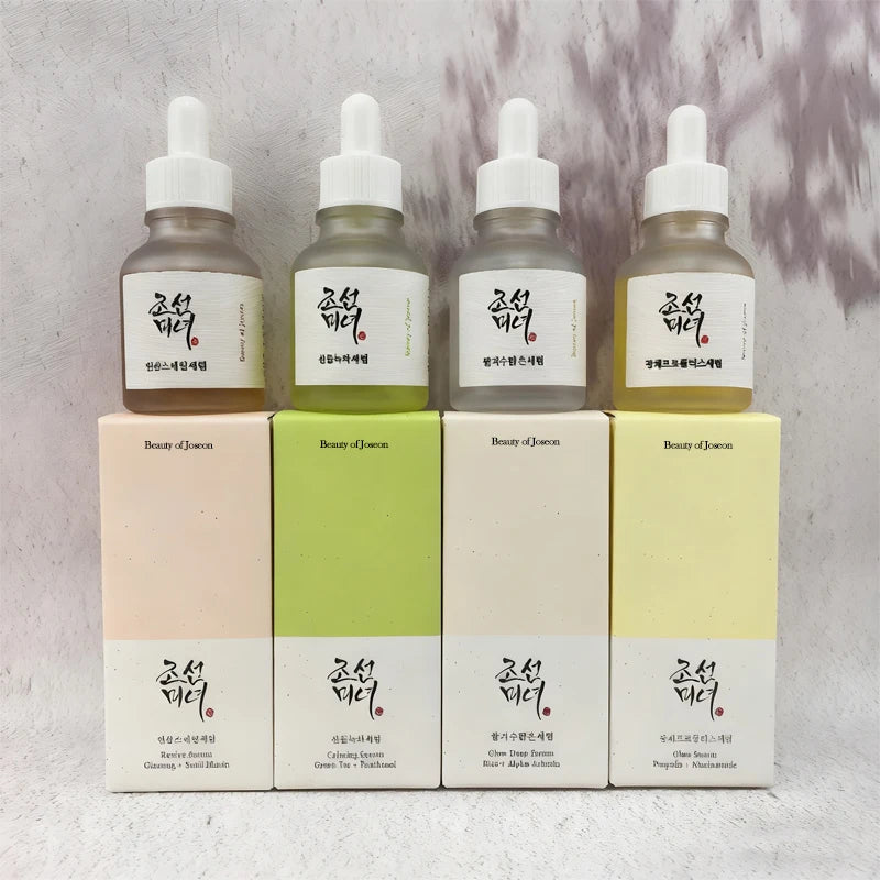 Glass serum bottle with dropper surrounded by botanical elements, representing a calming glow deep repair facial essence.