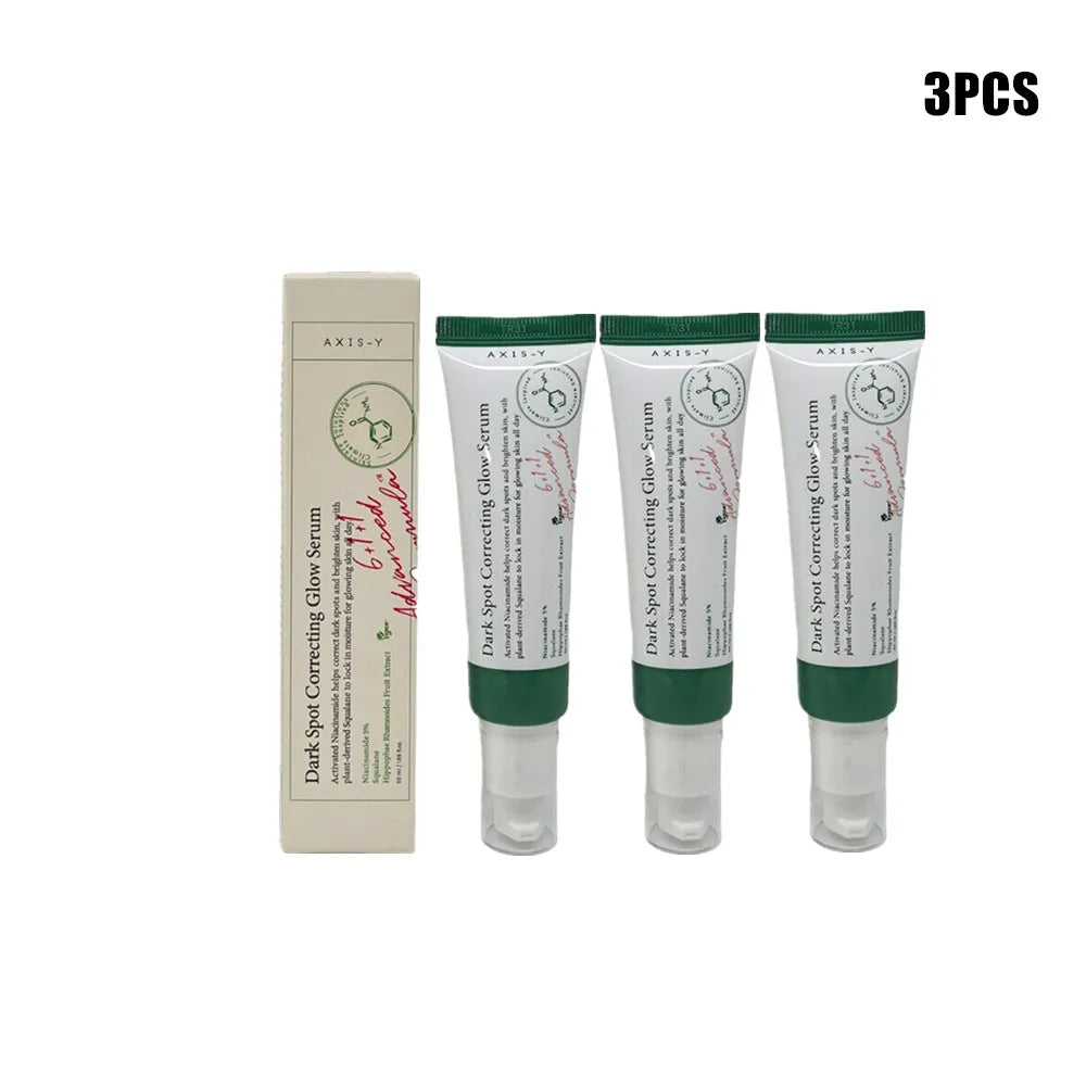 Dark spot correcting glow serum bottle with dropper on clean background.