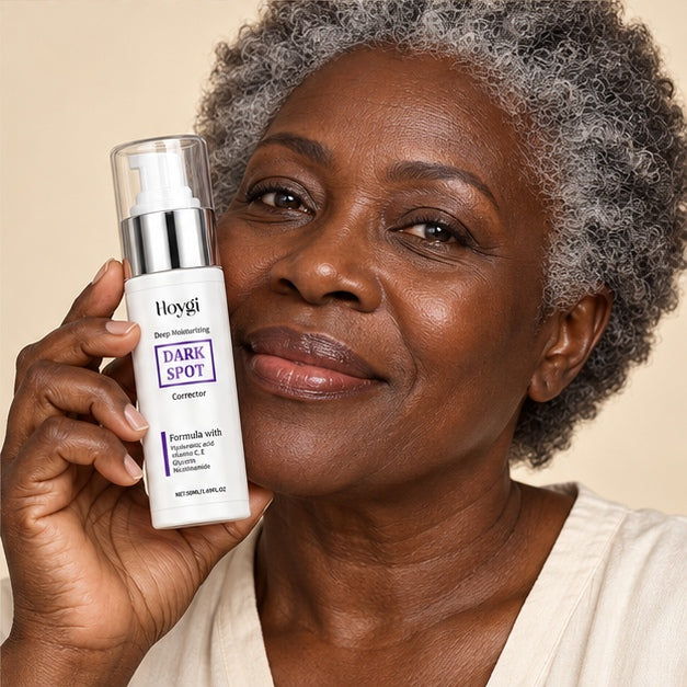 Adult holding a HOYGI Dark Spot Corrector 50 ml bottle