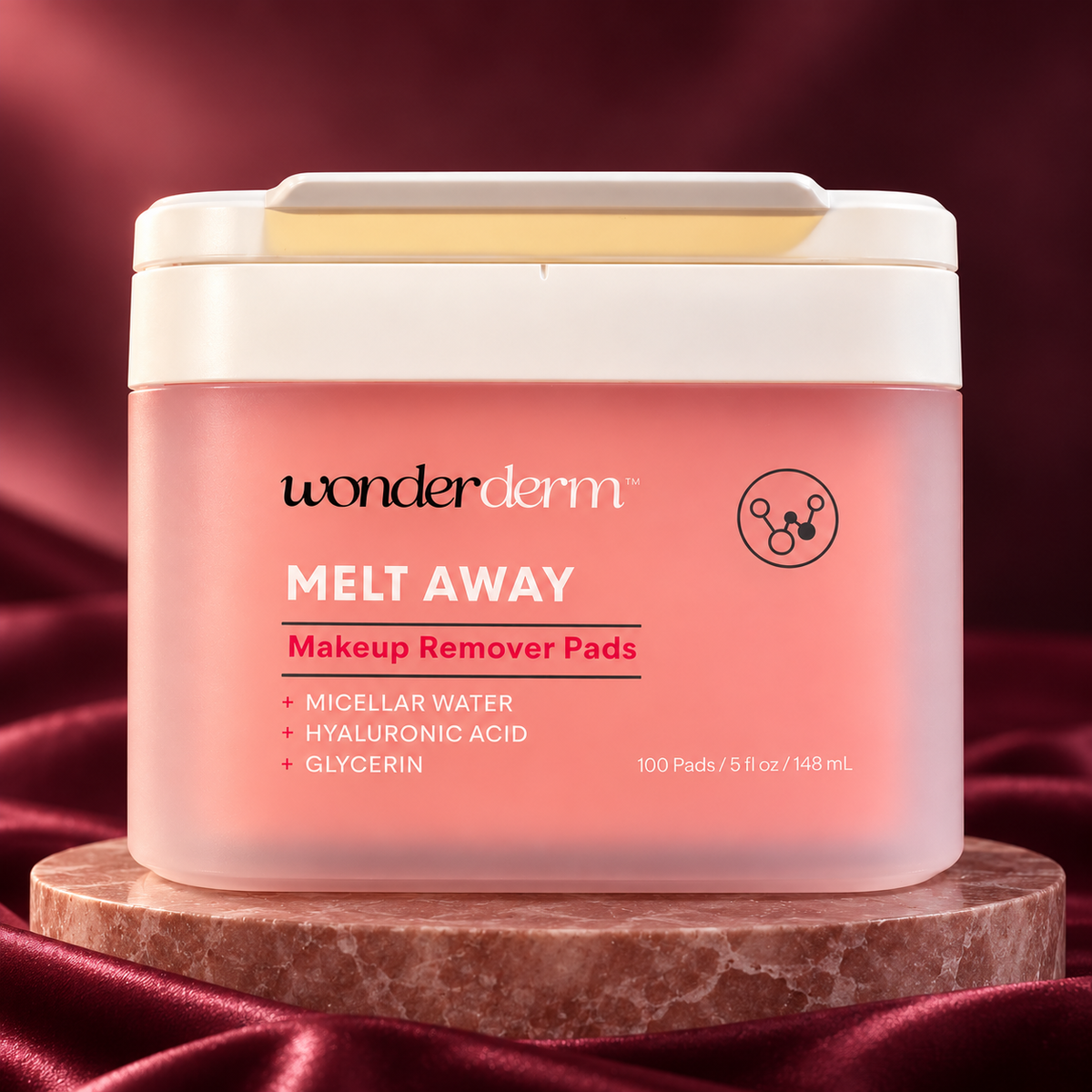 Wonderderm Melt Away Makeup Remover Pads, 100 pads and 148 ml, closed rectangular tub on a rose stone pedestal
