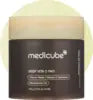 Round cotton toner pads soaked in clarifying kojic acid and turmeric solution in an open jar