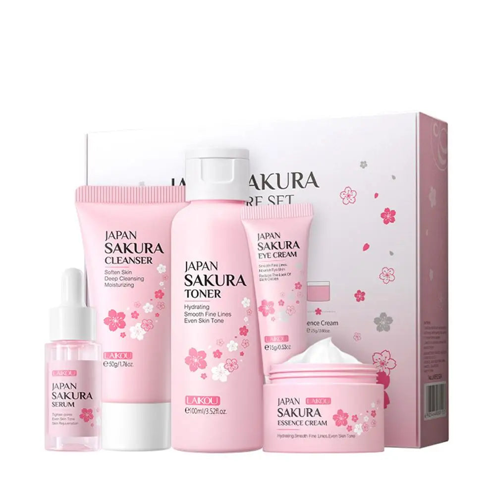 Six-piece facial brightening skincare set with sakura-themed packaging and assorted bottles, jars, and tubes.