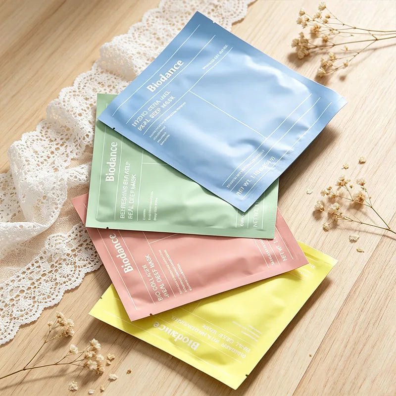 Facial essence mask product tube with cream swatch on clean background, representing deep hydration and soothing for…