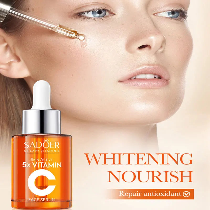 Vitamin C facial serum bottle with pump dispenser on white background