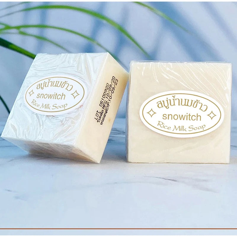 Creamy white soap bar with smooth rice milk texture resting on a neutral surface