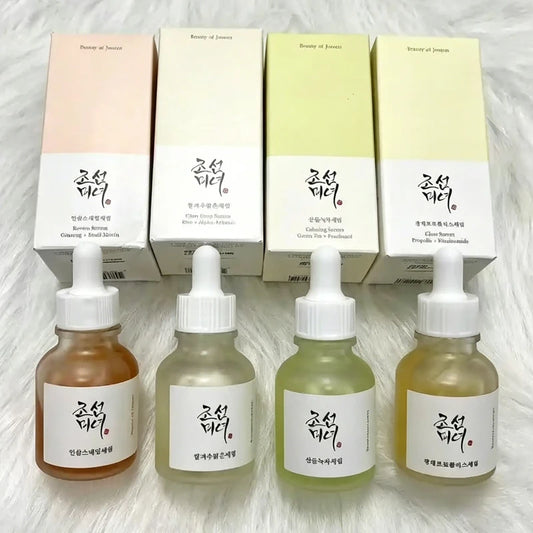 Glass serum bottle with dropper surrounded by botanical elements, representing a calming glow deep repair facial essence.