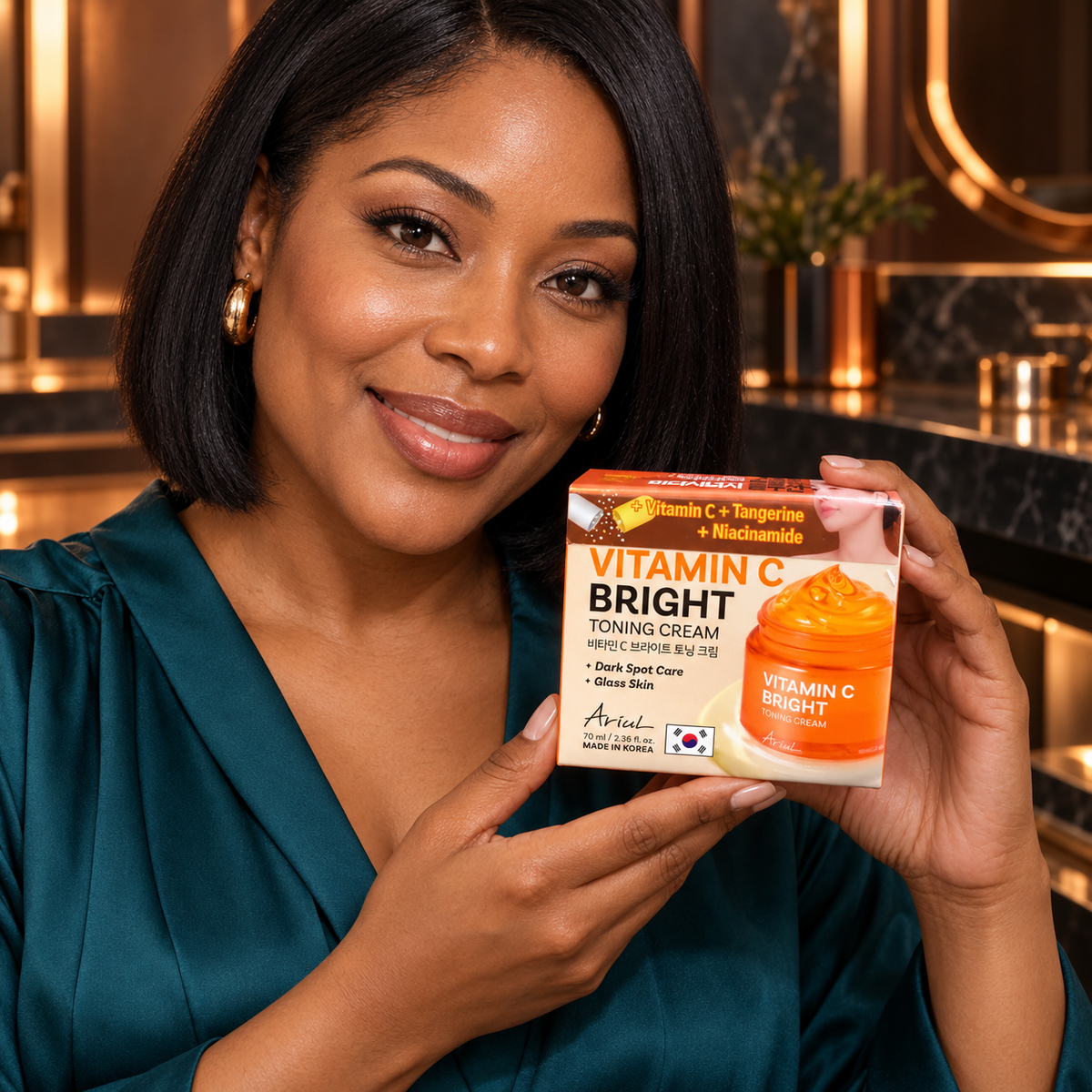 Adult woman presenting the closed Ariul Vitamin C Bright Toning Cream 70 ml carton toward the viewer
