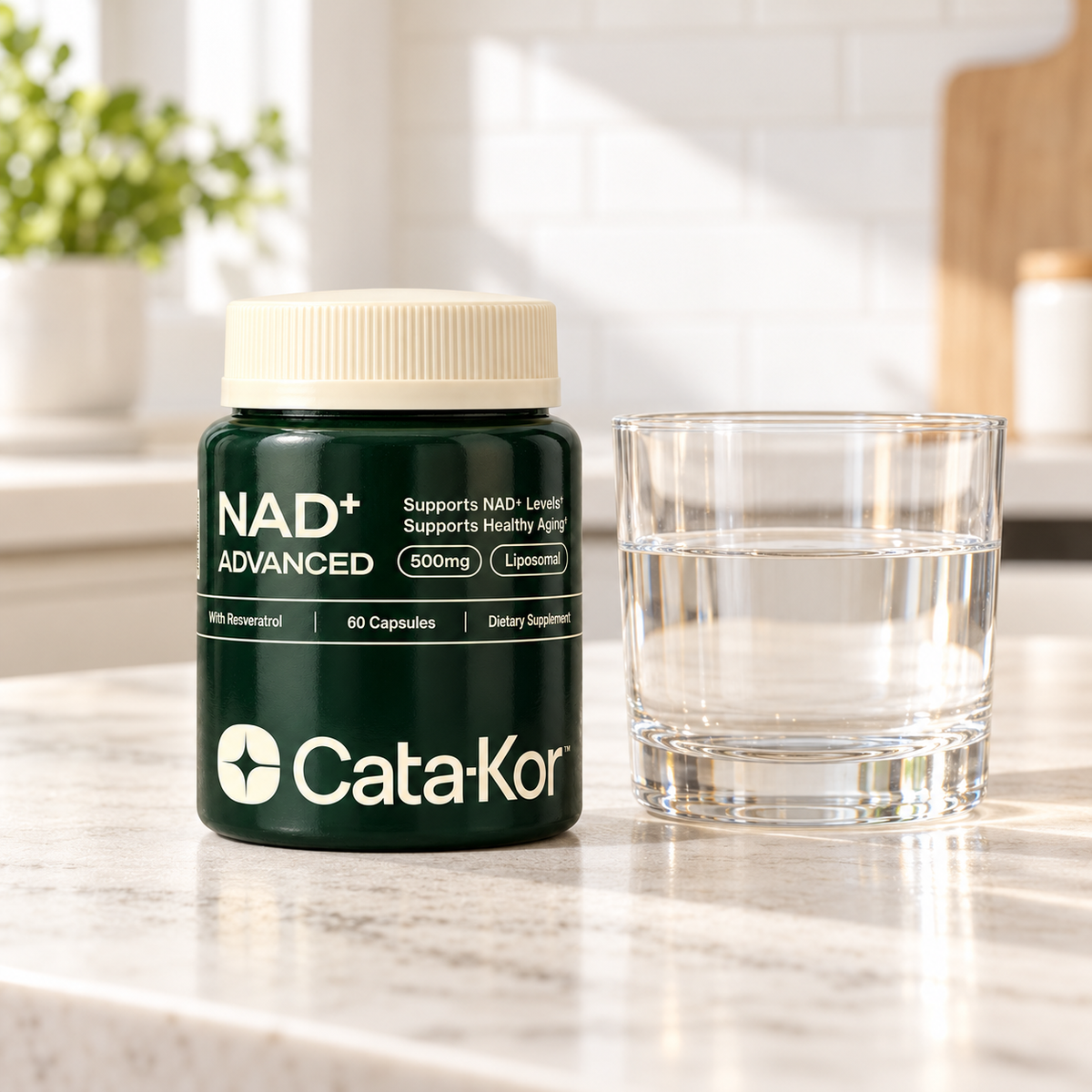 Cata-Kor NAD+ Advanced cream-cap bottle beside a clear glass of water