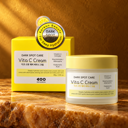 DEARBOO Vita C Cream 80 g — closed pale-yellow-lidded jar with original yellow carton on amber stone