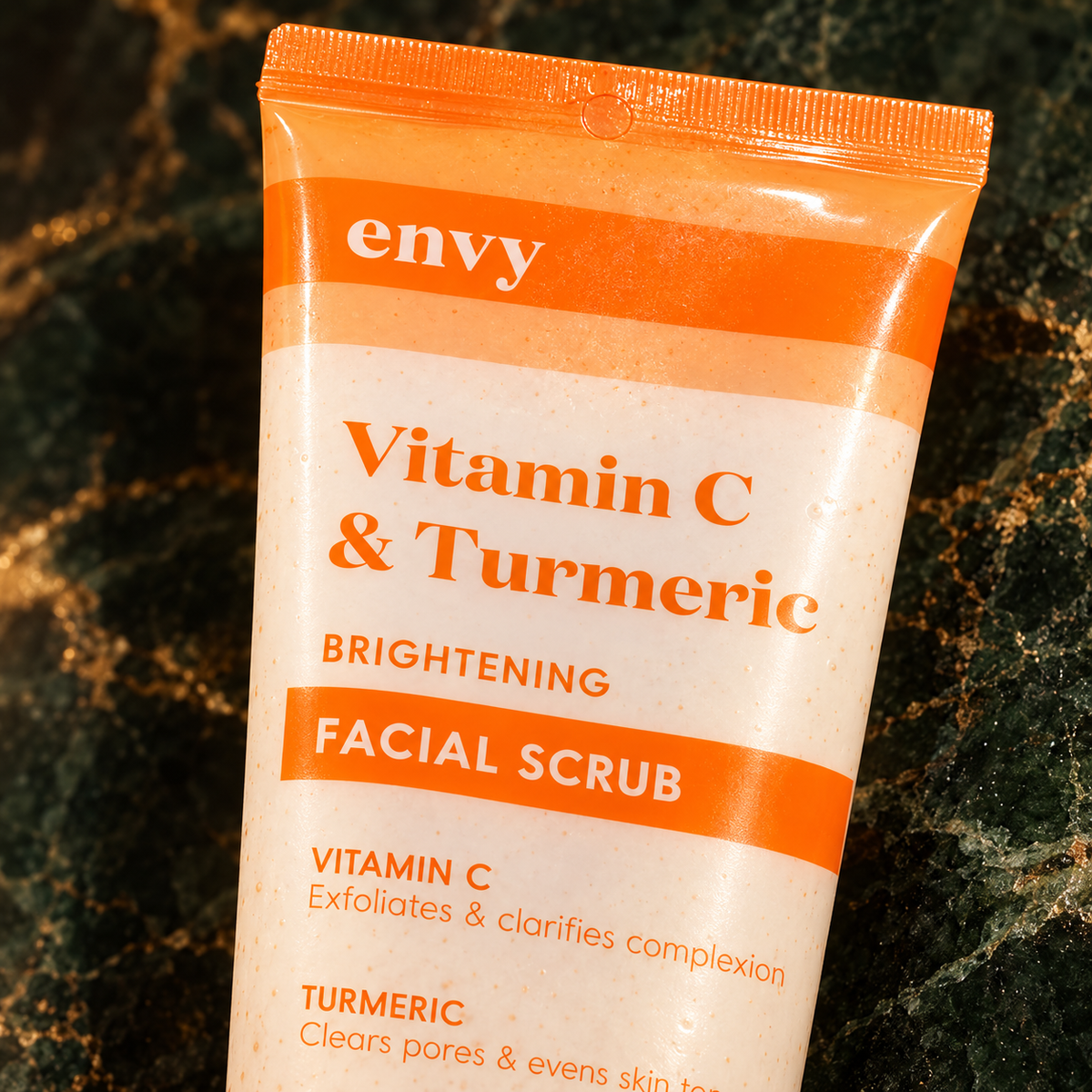 Close-up of the Envy Vitamin C & Turmeric Brightening Facial Scrub front label and sealed tube crimp
