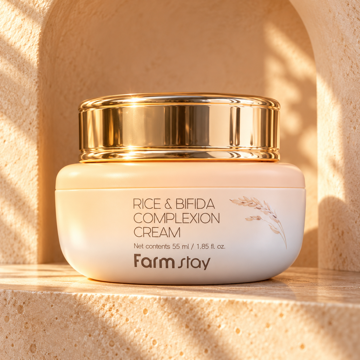 Farmstay Rice & Bifida Complexion Cream 55 ml in a warm gold alcove