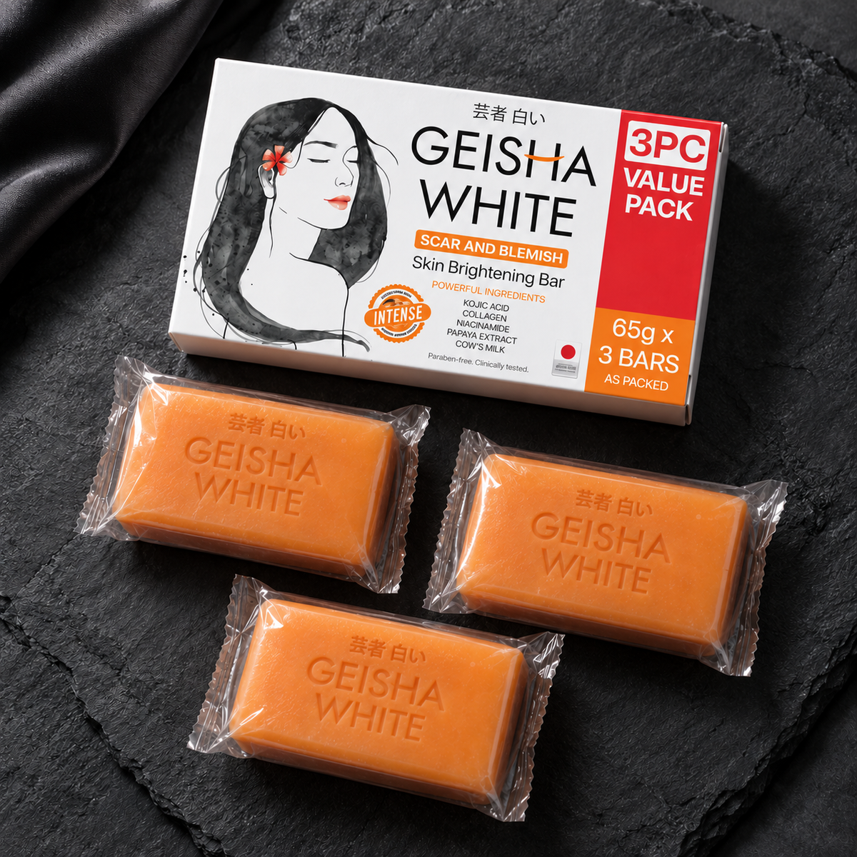 Geisha White Intense carton with three individually wrapped orange 65 g bars on slate