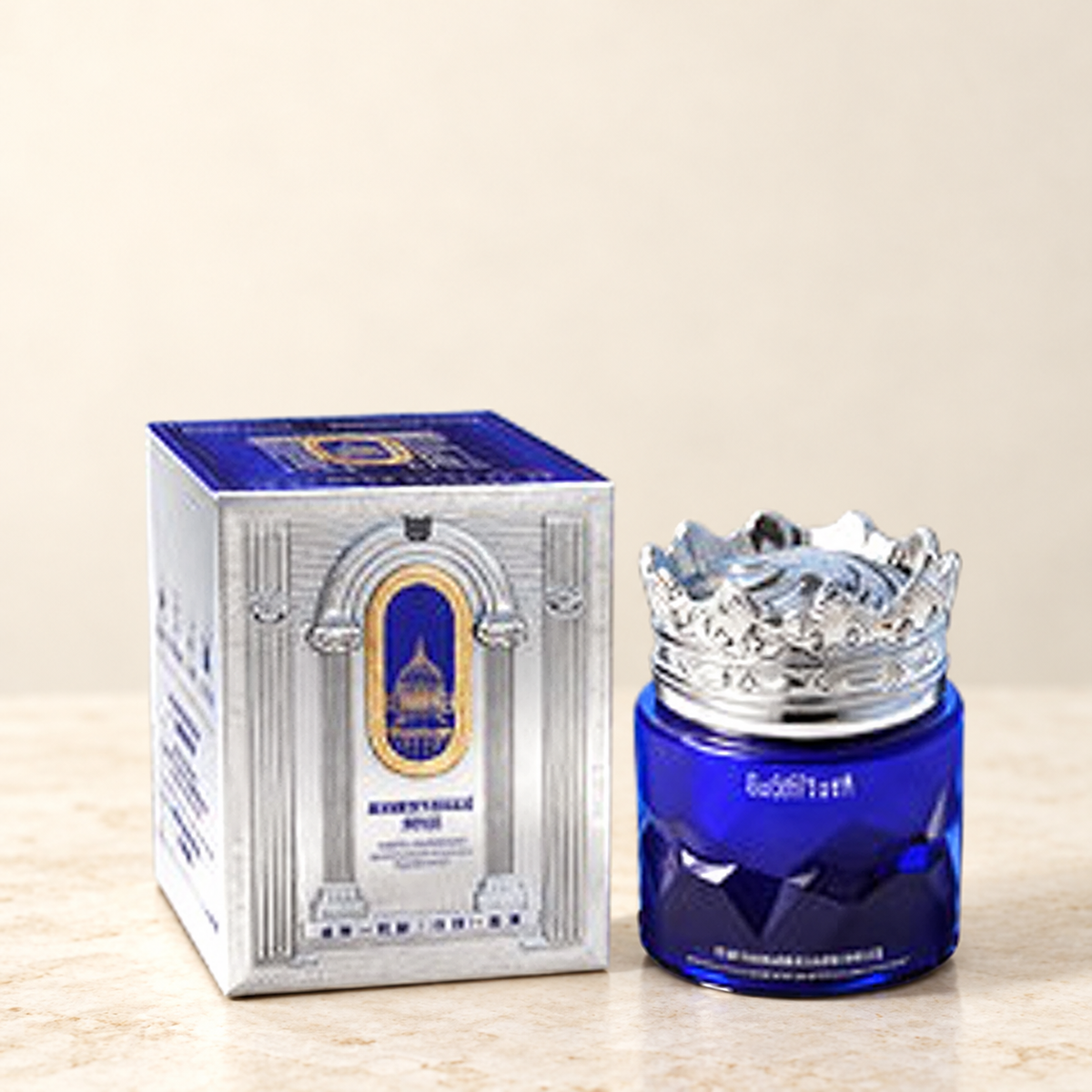 GUSHIYUTA blue crown-lid facial cream and original silver carton on a neutral background
