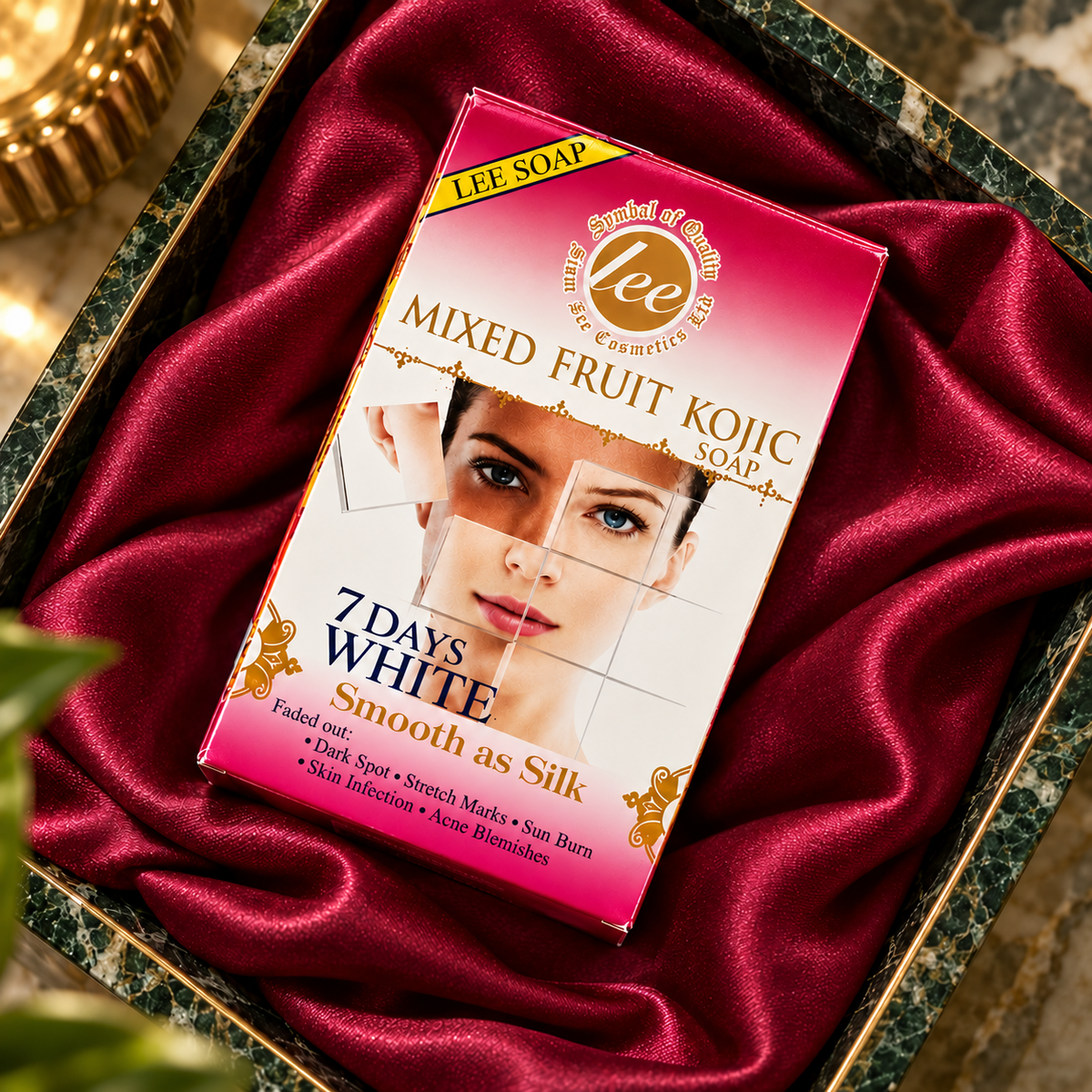 Lee Mixed Fruit Kojic Soap — closed carton front in a burgundy satin flatlay