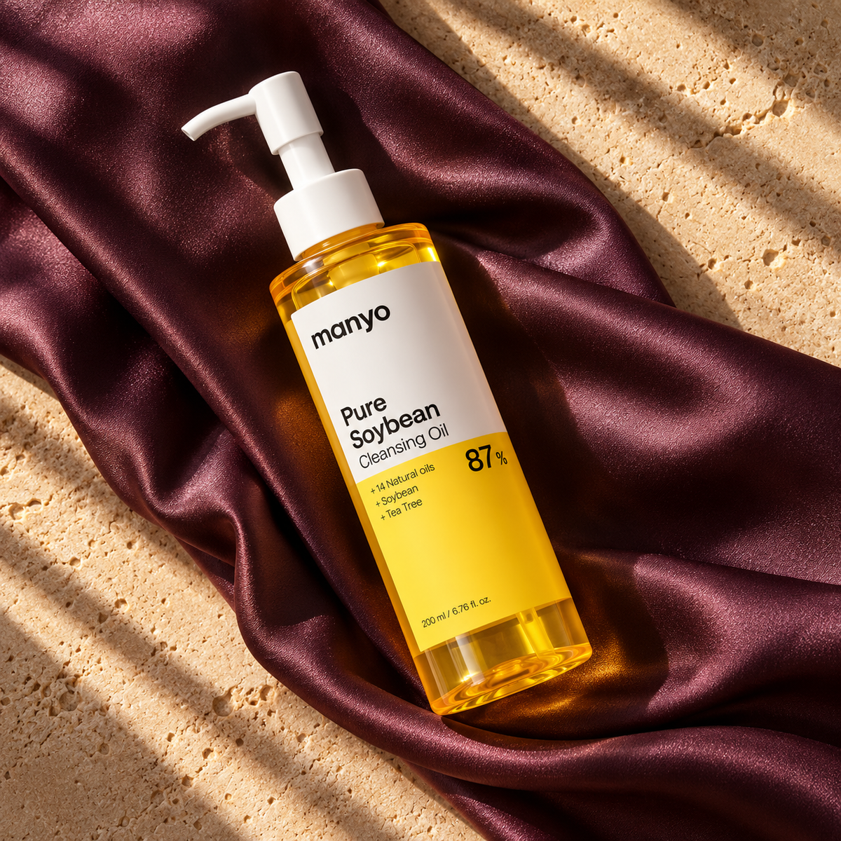 ma:nyo Pure Soybean Cleansing Oil 200 ml in an original plum satin flat lay