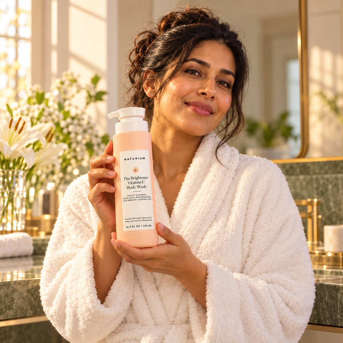 Model presenting NATURIUM The Brightener body wash