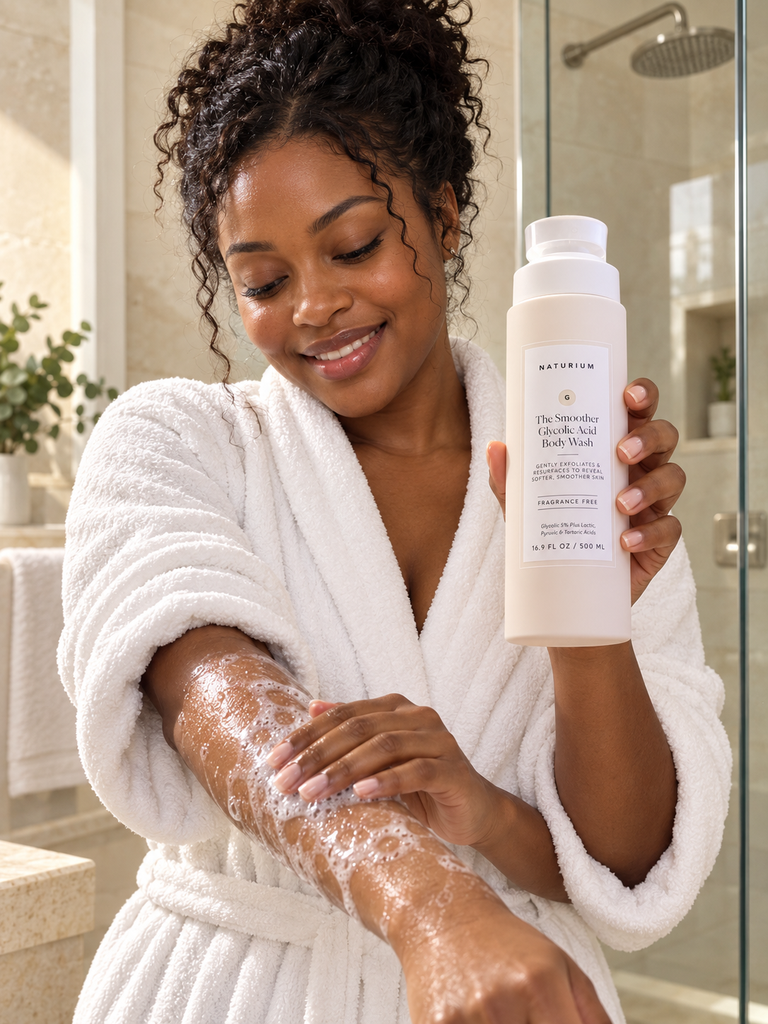 Adult applying NATURIUM The Smoother Glycolic Acid Body Wash