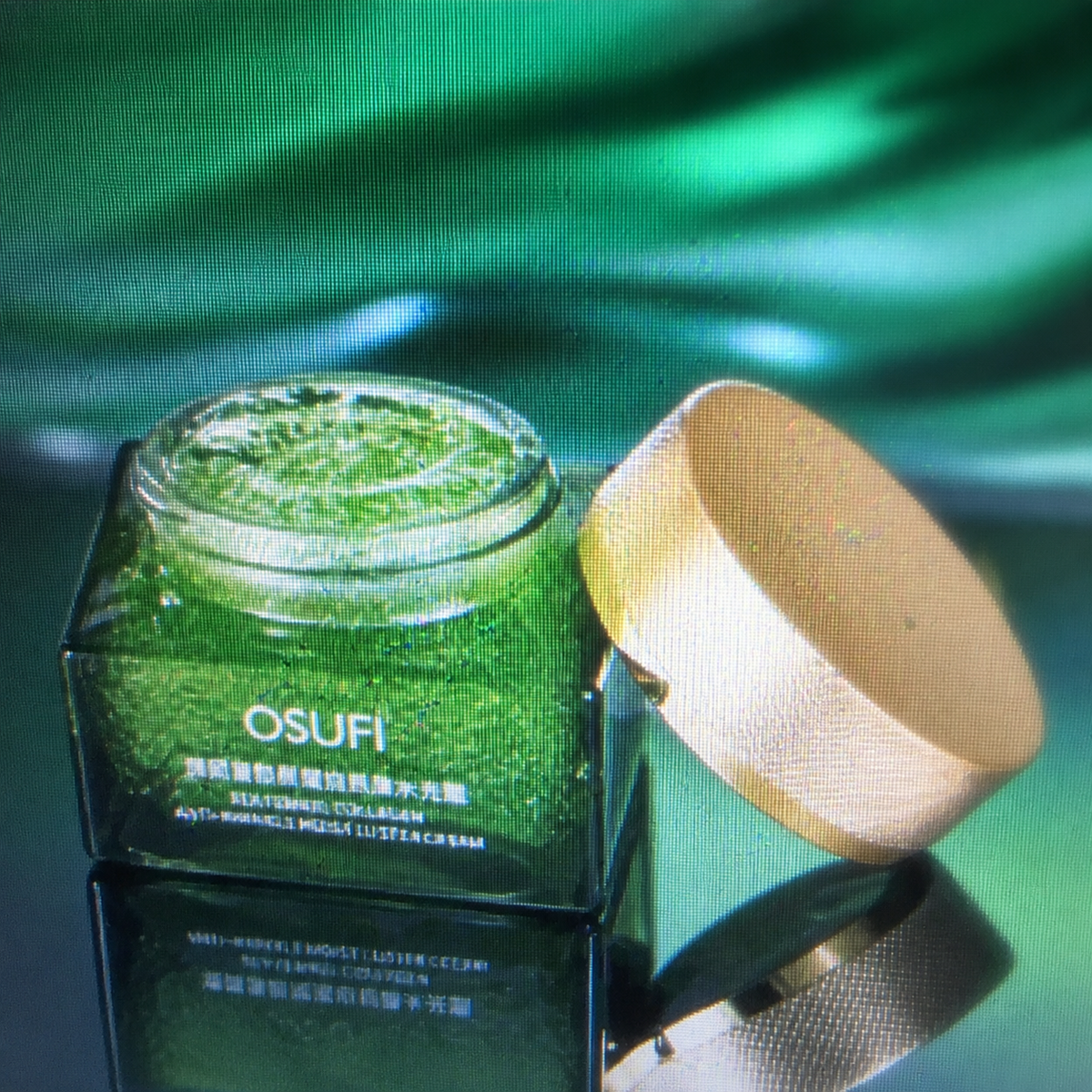OSUFI Sea Fennel green jar and gold lid — open-container detail from supplied low-resolution reference