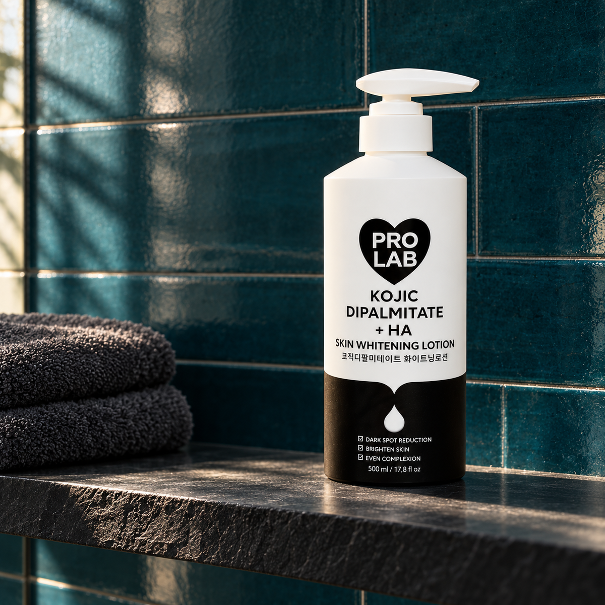 PRO LAB Kojic Dipalmitate + HA Body Lotion 500 ml pump bottle on a slate shelf against deep teal tile; styled product photograph.